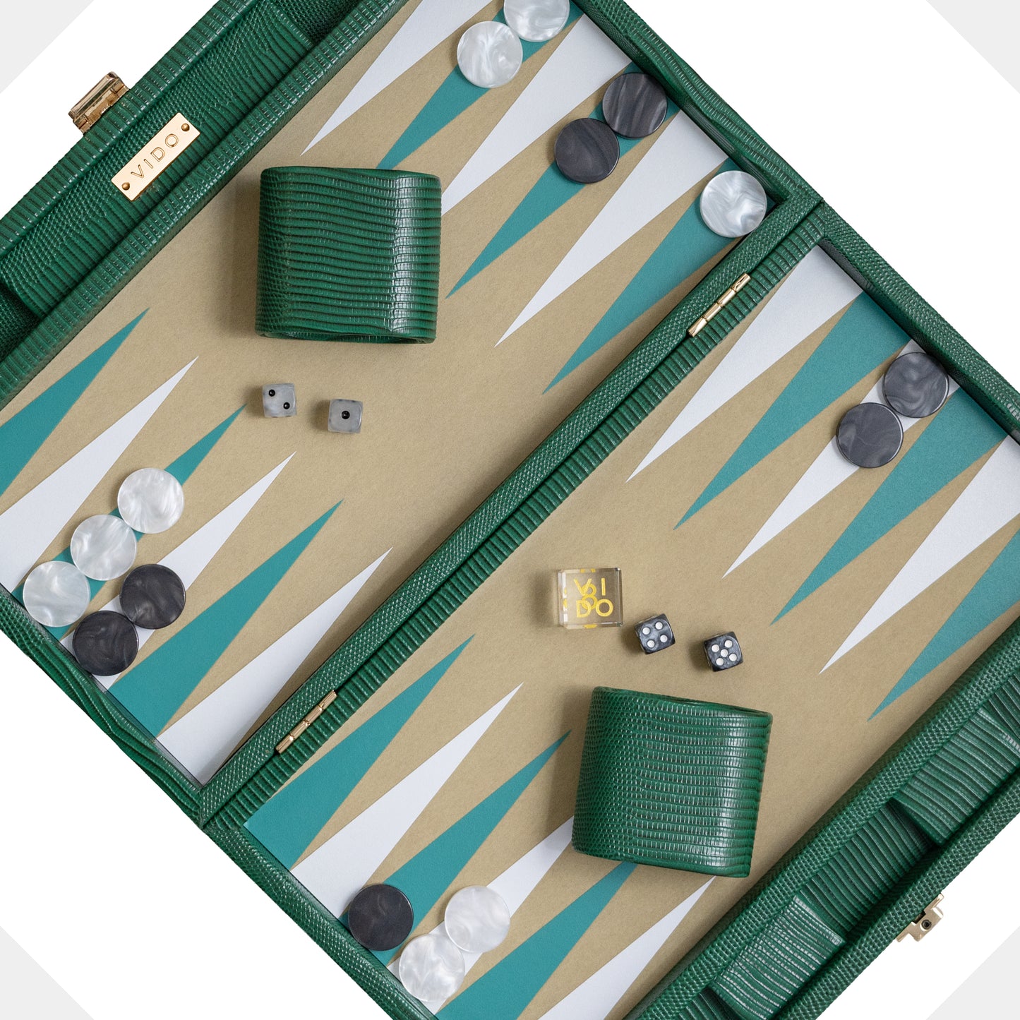 Backgammon set with pieces and dice on a green and beige board by VIDO