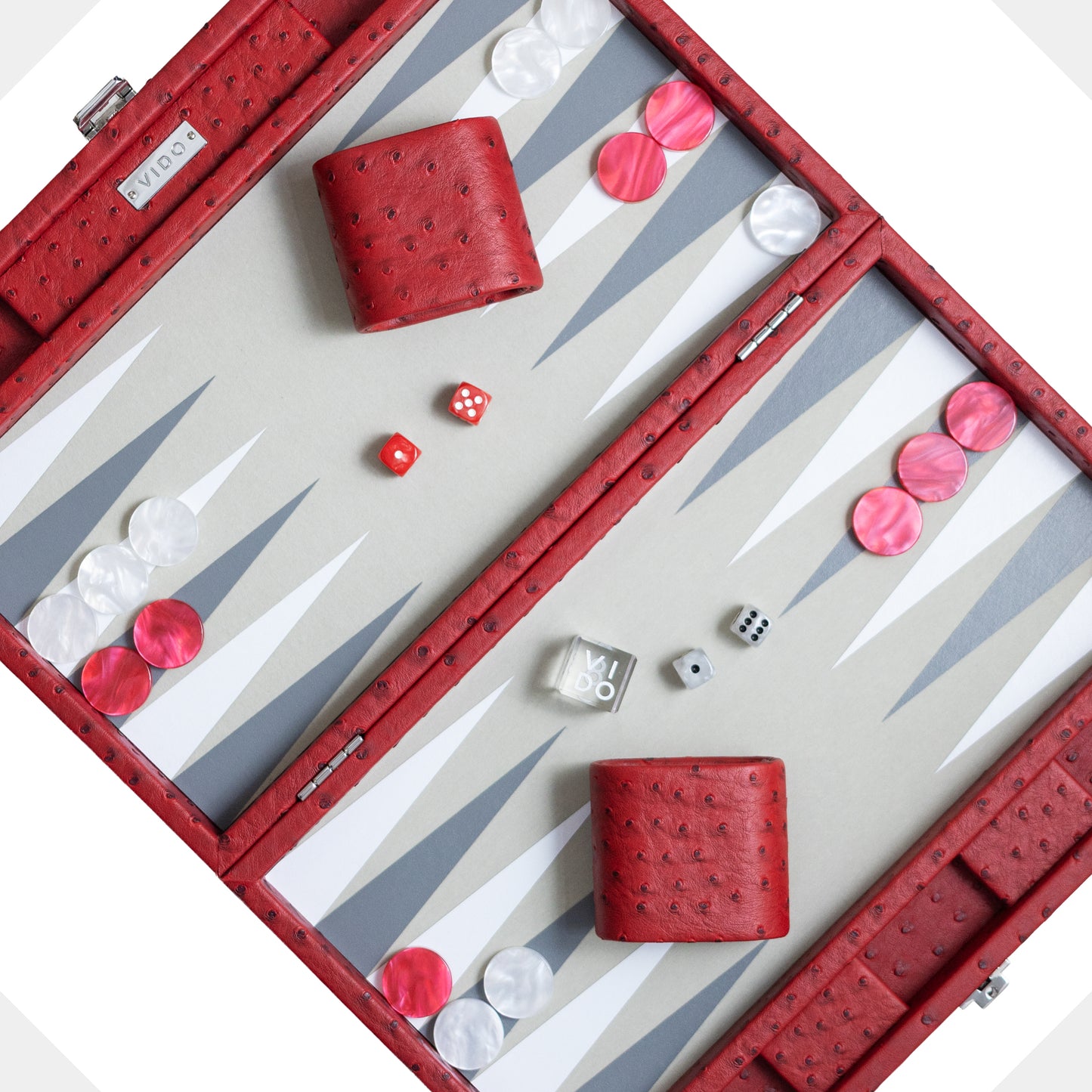 Backgammon set with red pieces and dice on a white background by VIDO