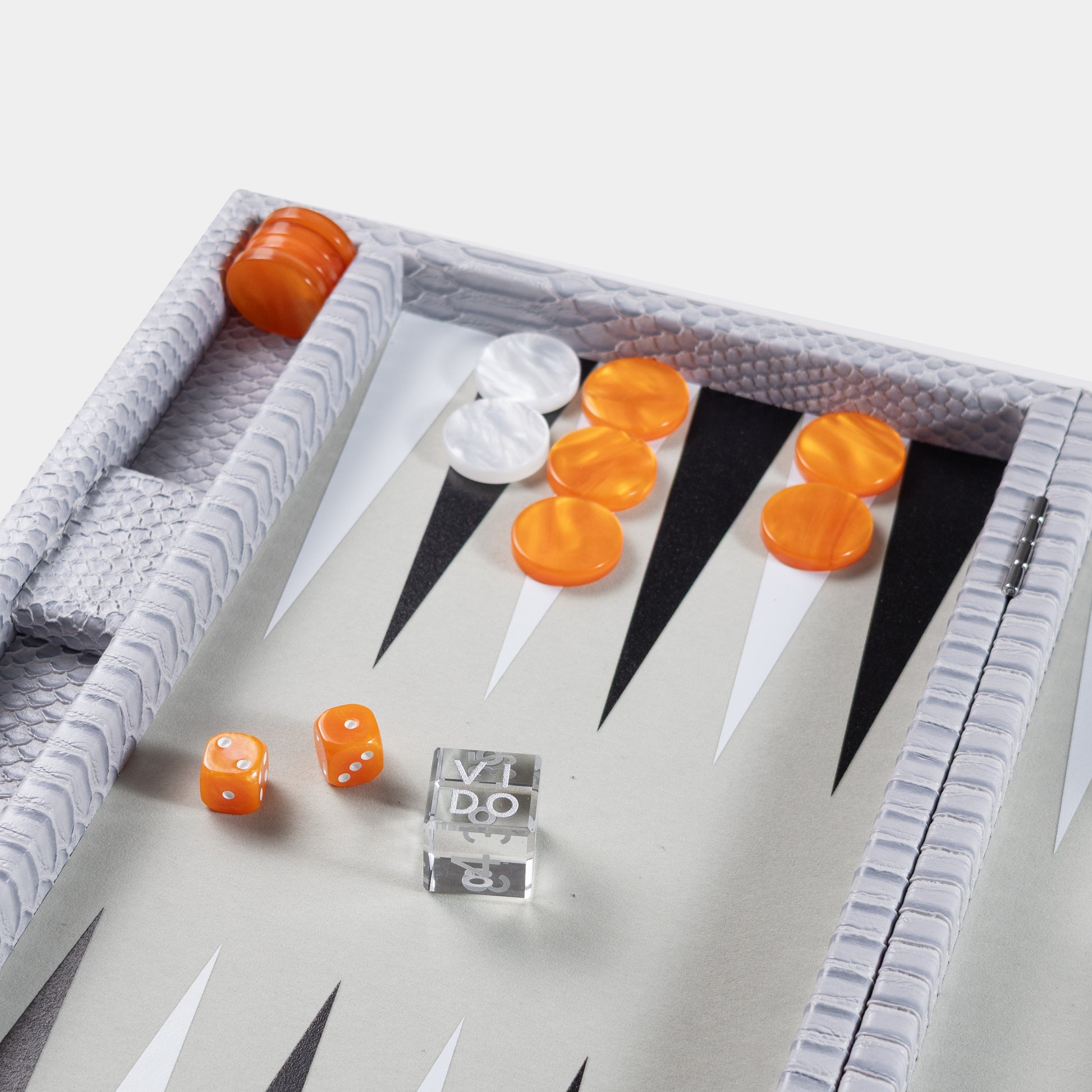 Backgammon board grey with orange and white pieces on a light gray background by VIDO