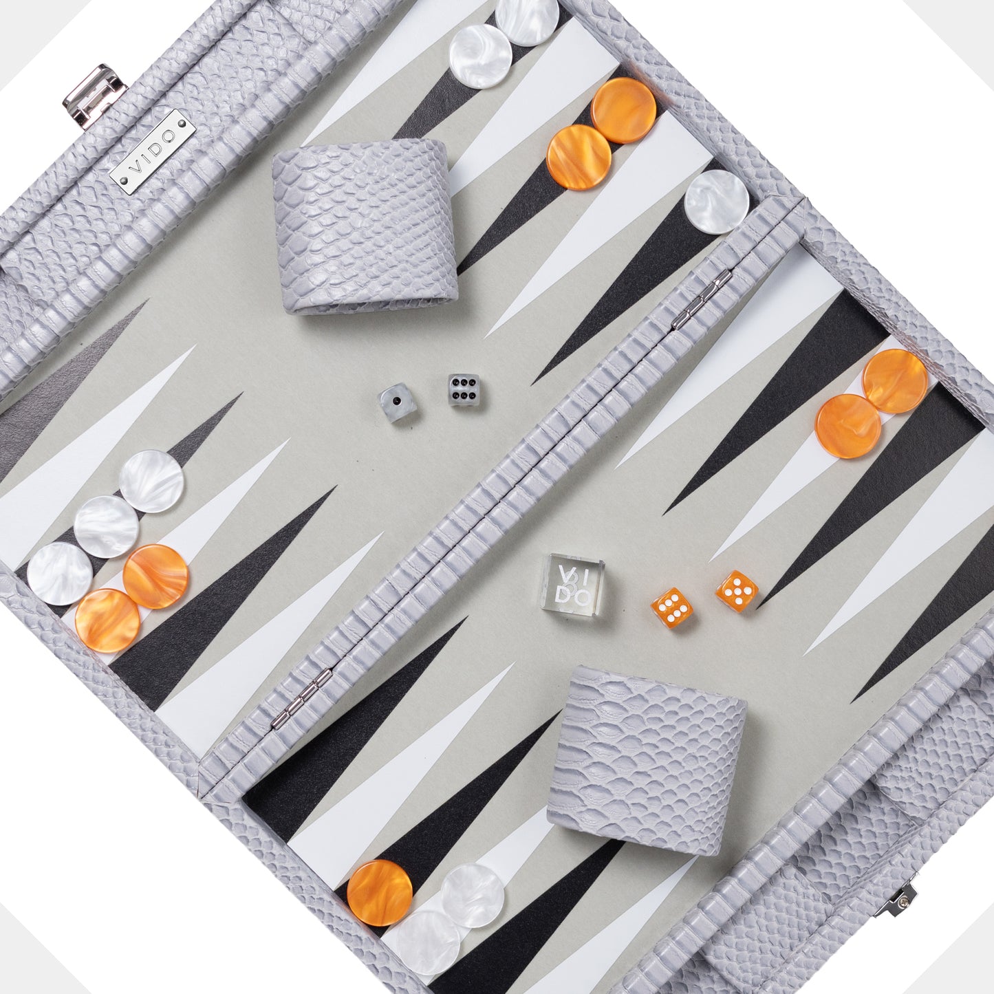 Backgammon set grey and snake pattern with pieces and dice on a light gray background by VIDO