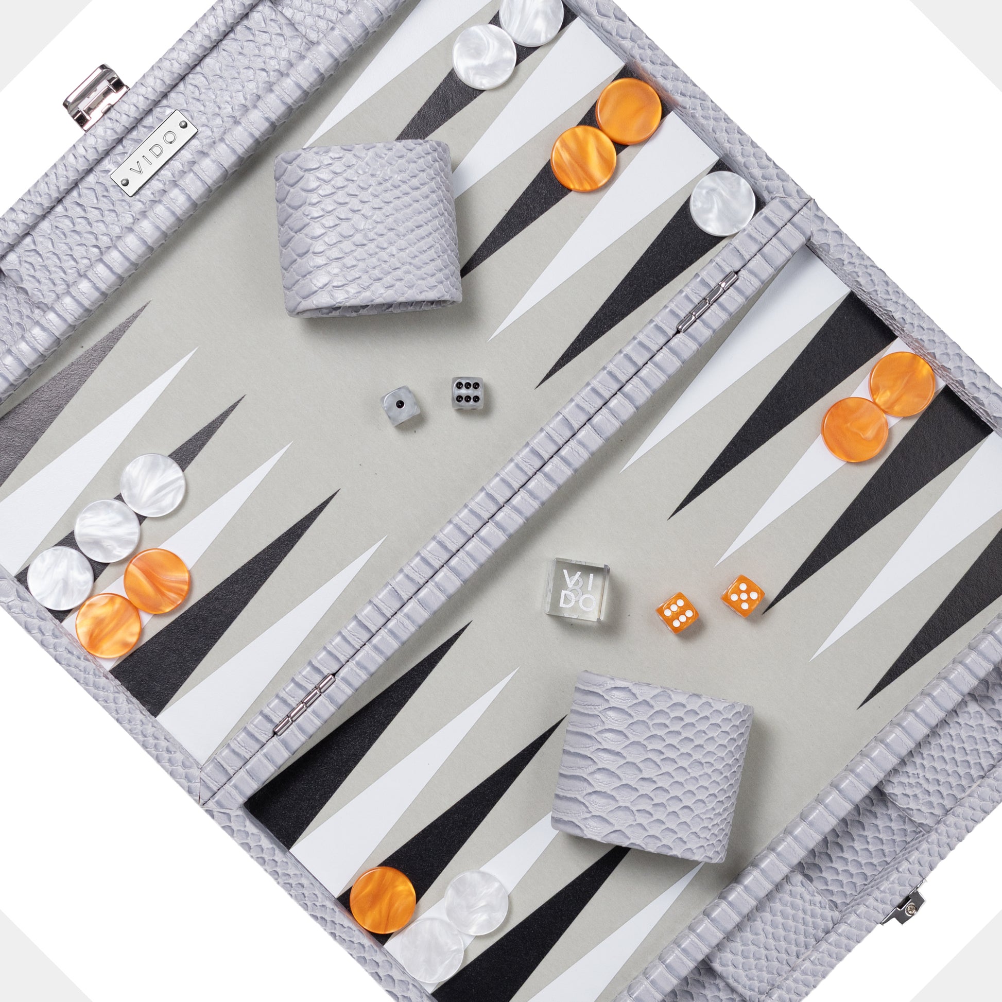 Backgammon set grey and snake pattern with pieces and dice on a light gray background by VIDO