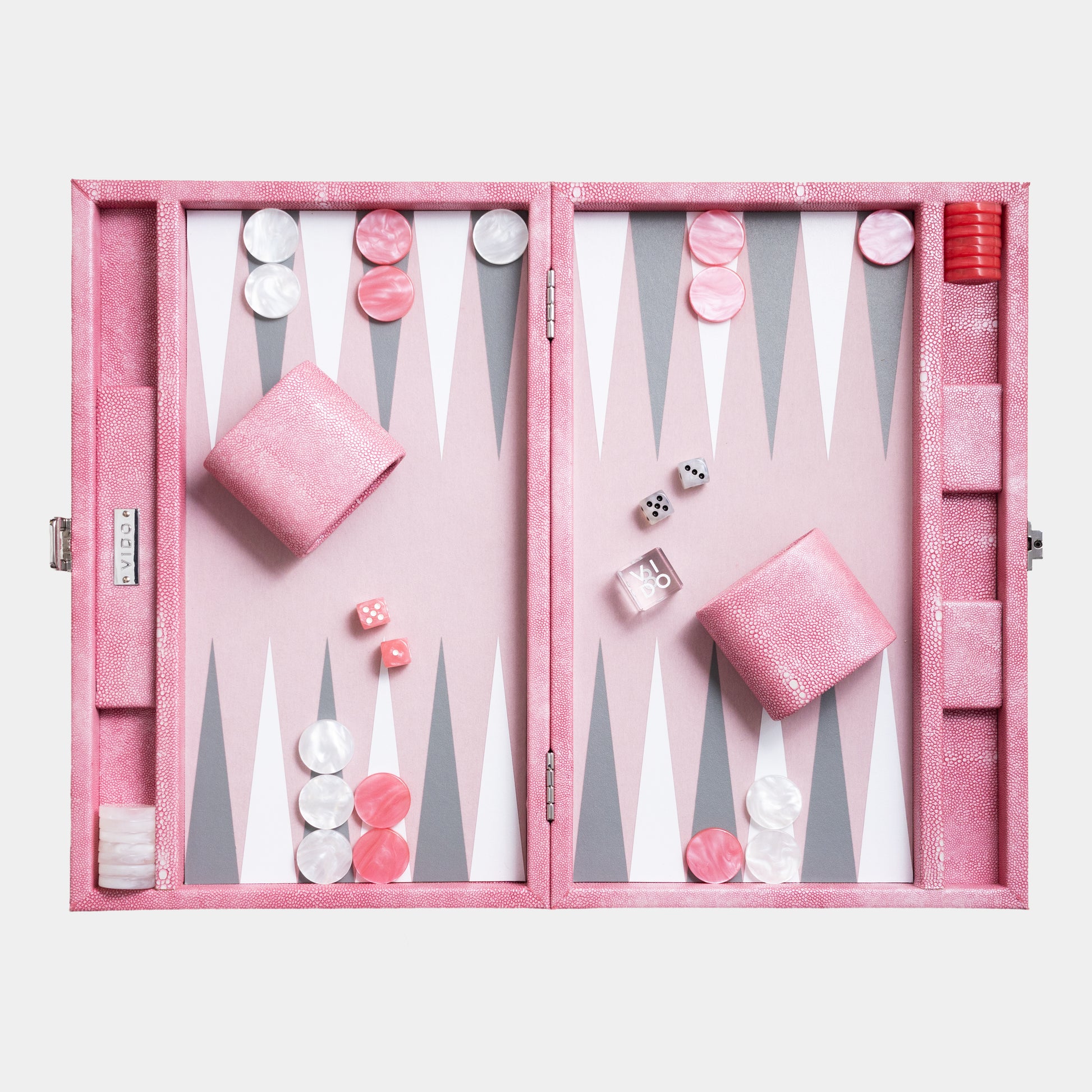 Pink backgammon set with pieces and dice on a white background by VIDO